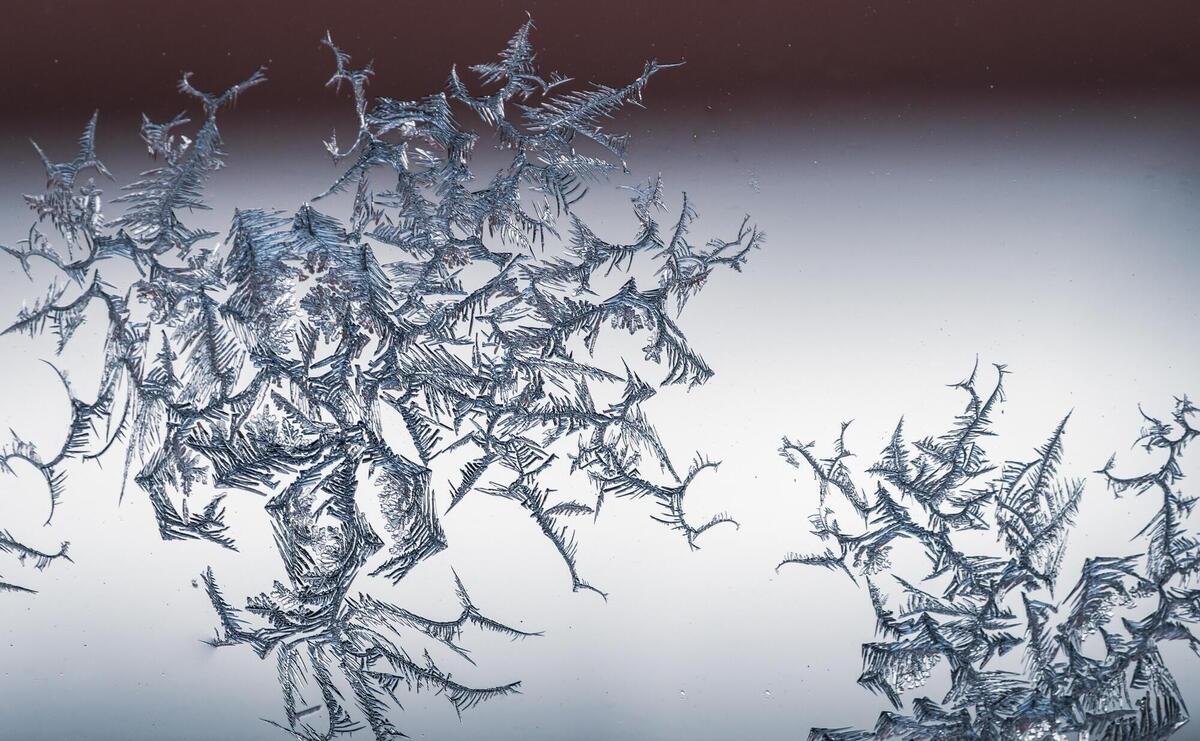A snowflake on a glass from frost.