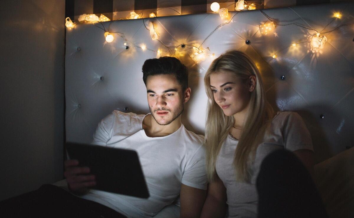 Couple watching film on tablet.