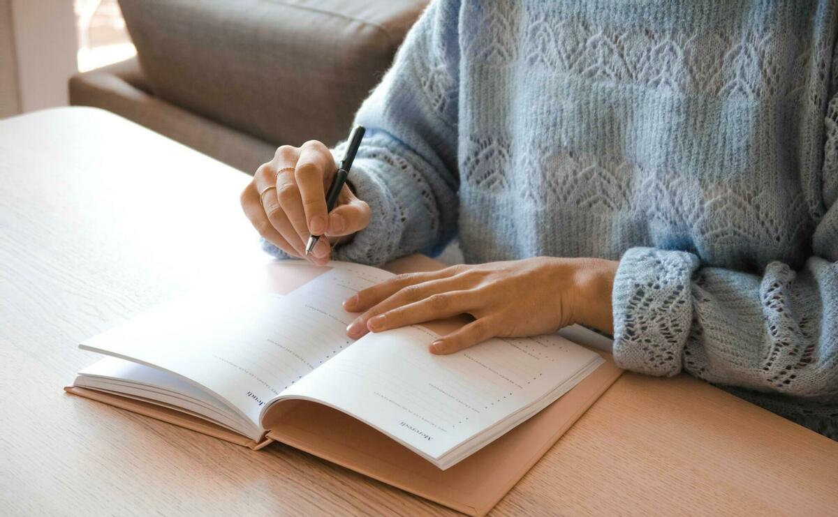 A person is writing in a notebook.
