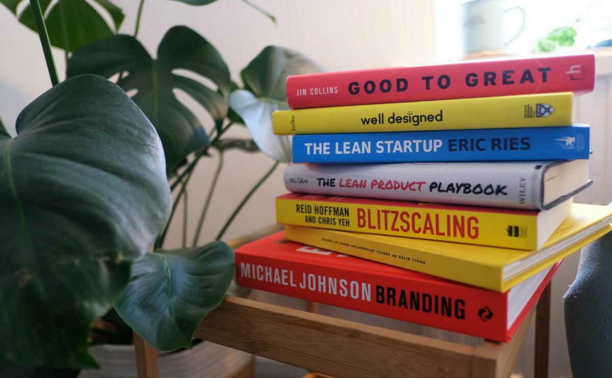 A pile of colorful books. Includes startup classics, like "The Lean Startup" and "Blitzscaling".