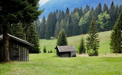Beautiful landscape with wooden cabins and green trees