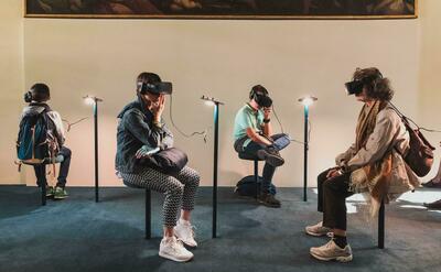Four person playing virtual reality goggles.