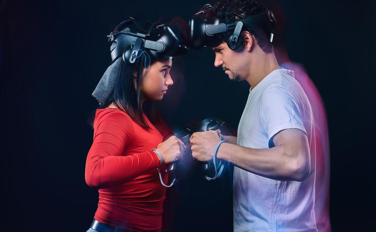 Couple of pro gamers with vr headsets participate in the game battle.