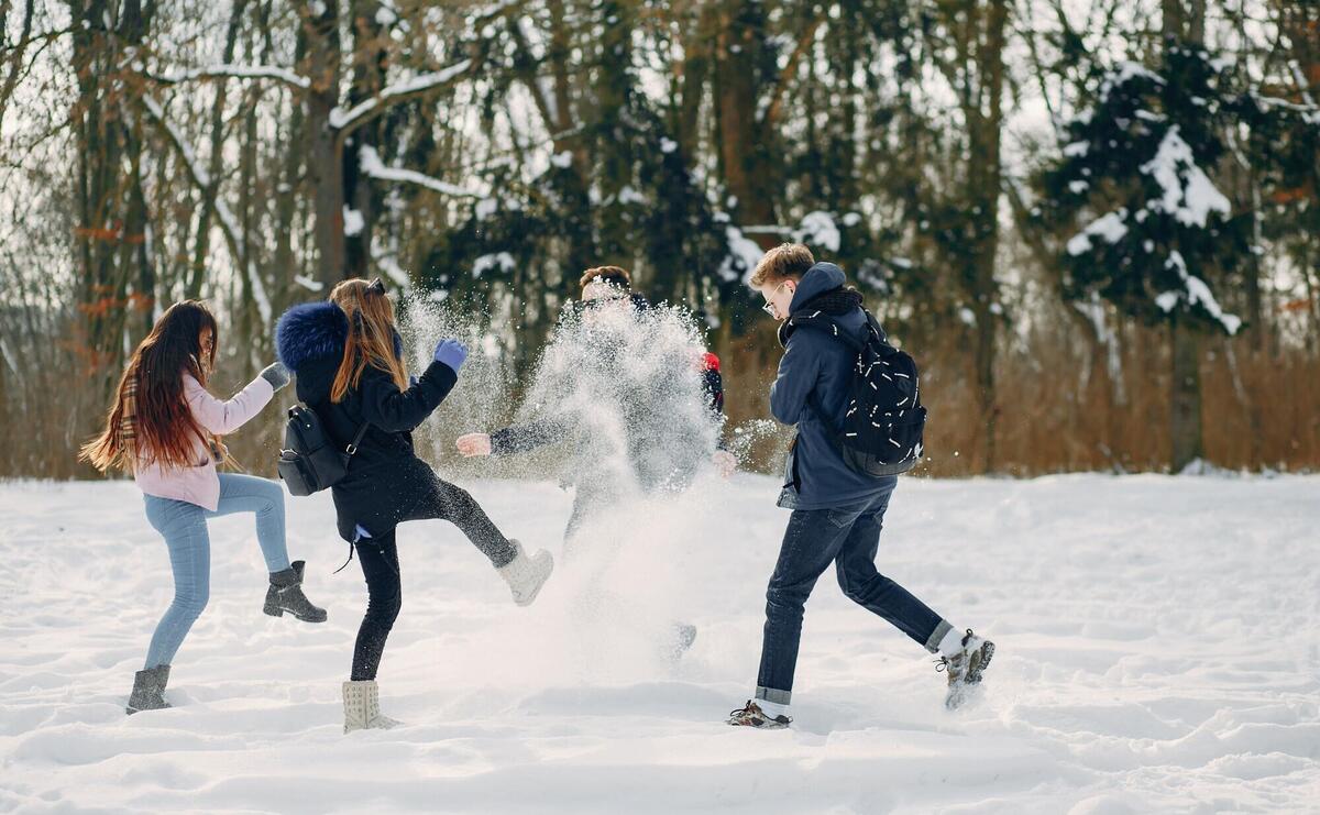 Four teenagers planning outdoors on the snow.