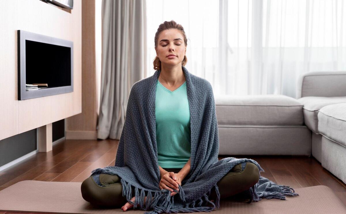 Young woman practicing yoga to relax