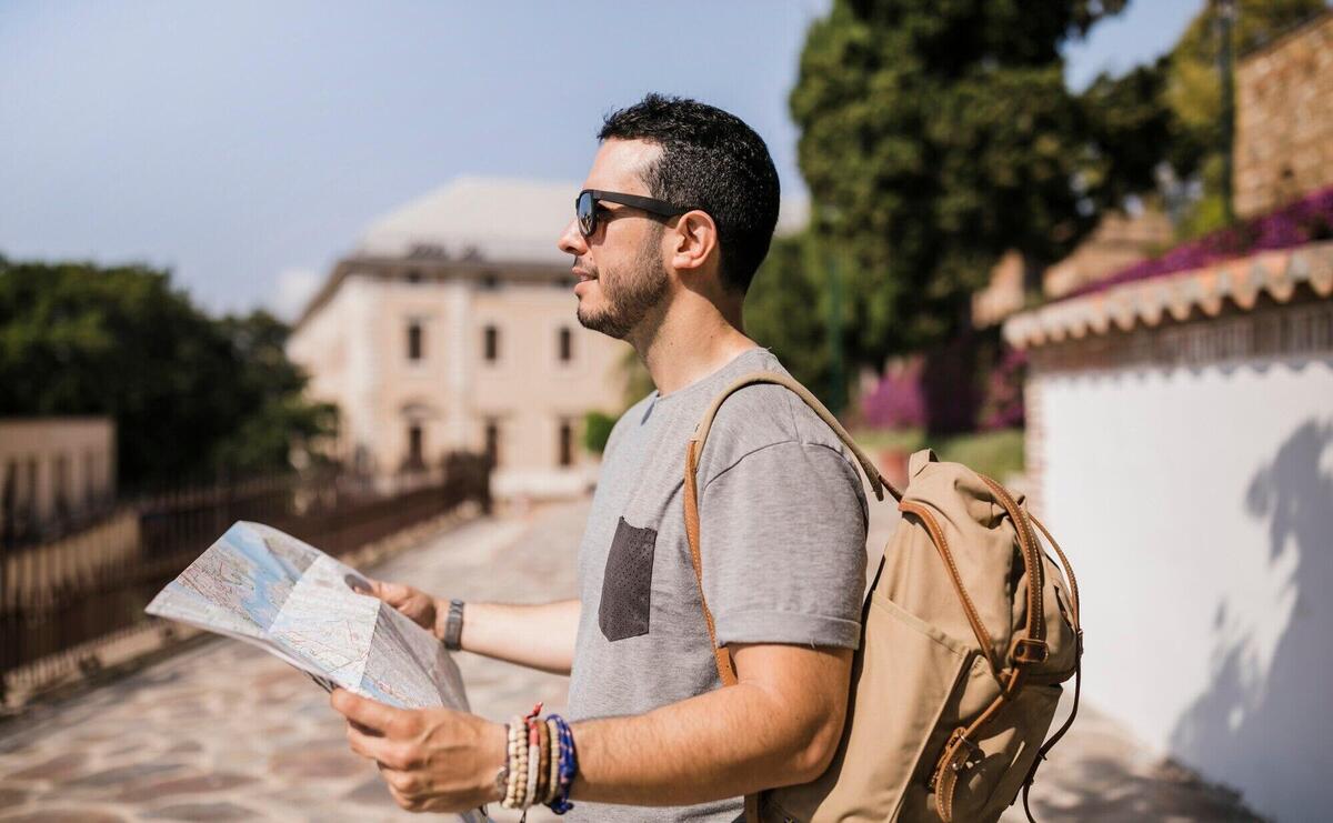 Close-up of male tourist holding map in his hand