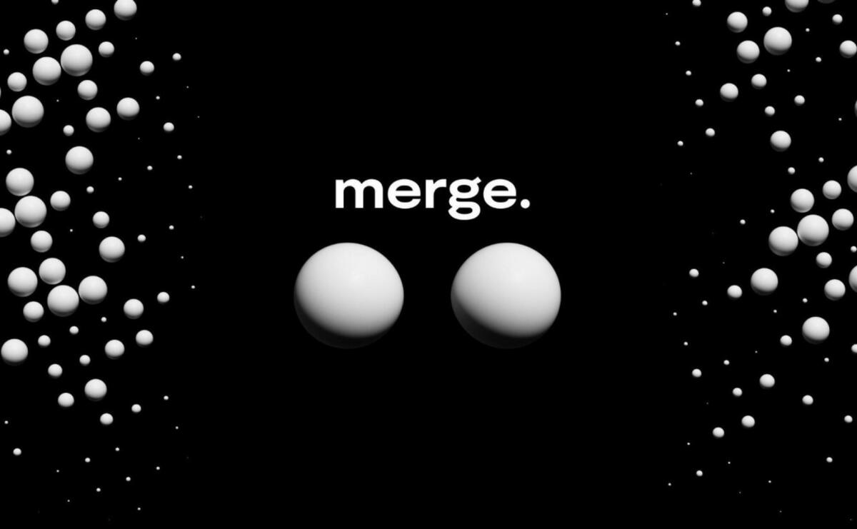 Two white bubles are merging in front of a black background.