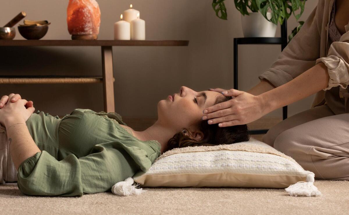 Person conducting reiki therapy.