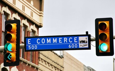 A blue road sign with "e commerce" written on it.