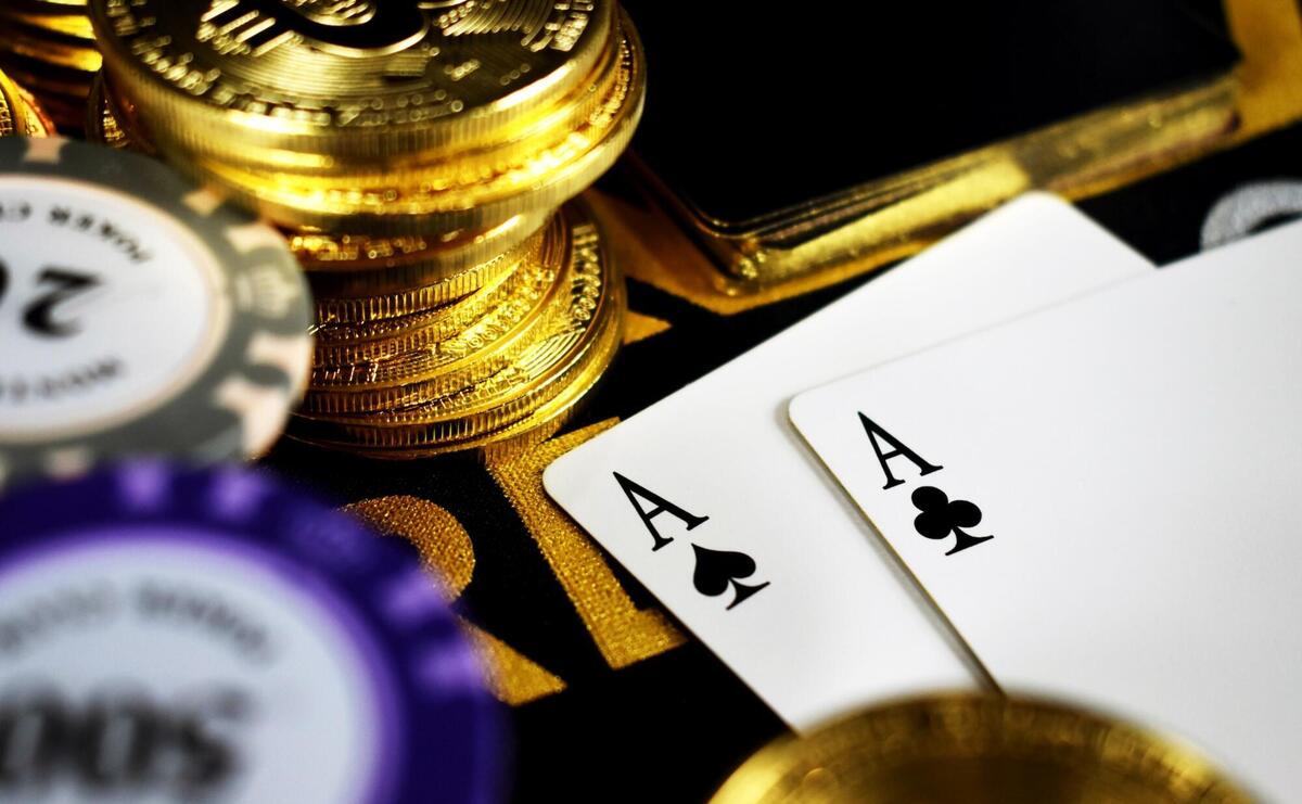 Golden poker chips and two aces.