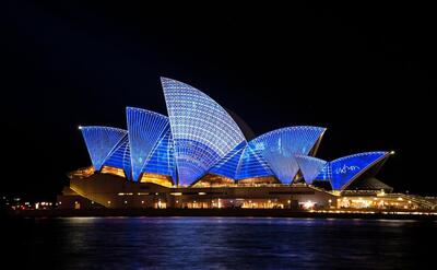 Night photo of the Sydney Opera House.