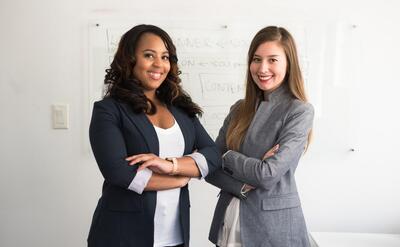 Women standing in front of a whiteboard.