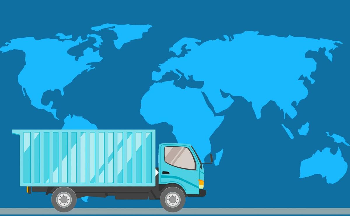 An illustration of a truck going in front of the world map.