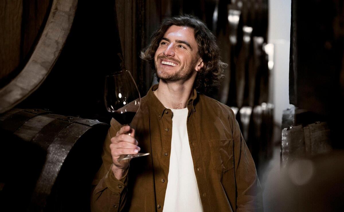 Smiley man in wine cellar medium shot