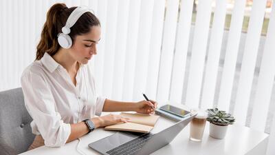 Businesswoman working with laptop and headphones