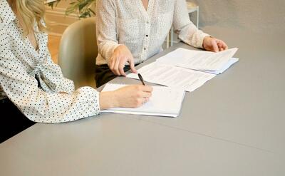 Woman is signing a contract.