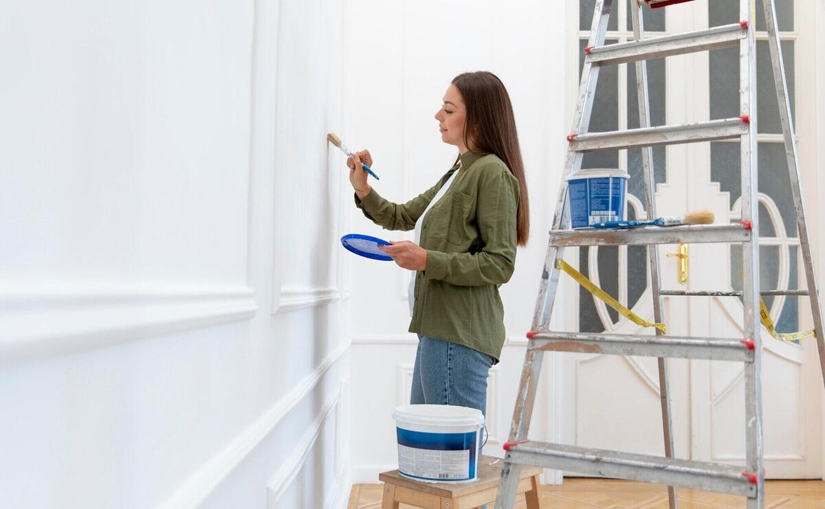 Medium shot woman painting wall at home
