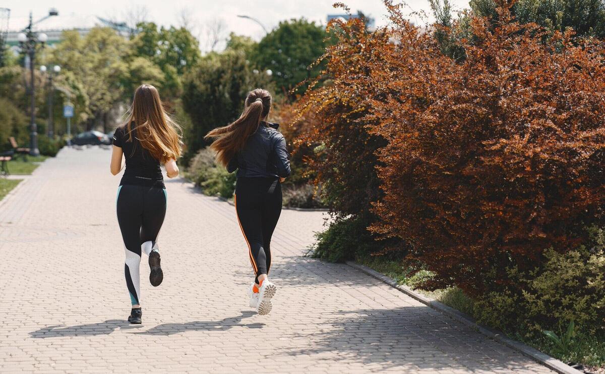 Sports girls training in a summer forest