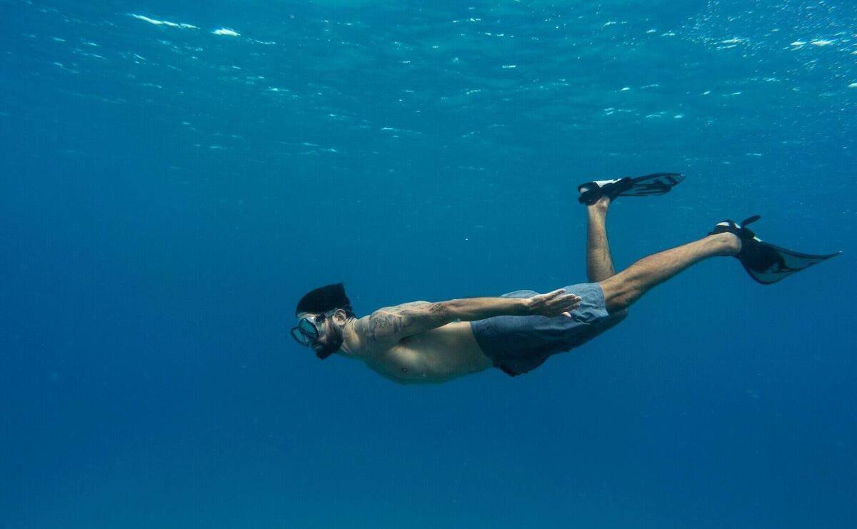 Man freediving with flippers underwater