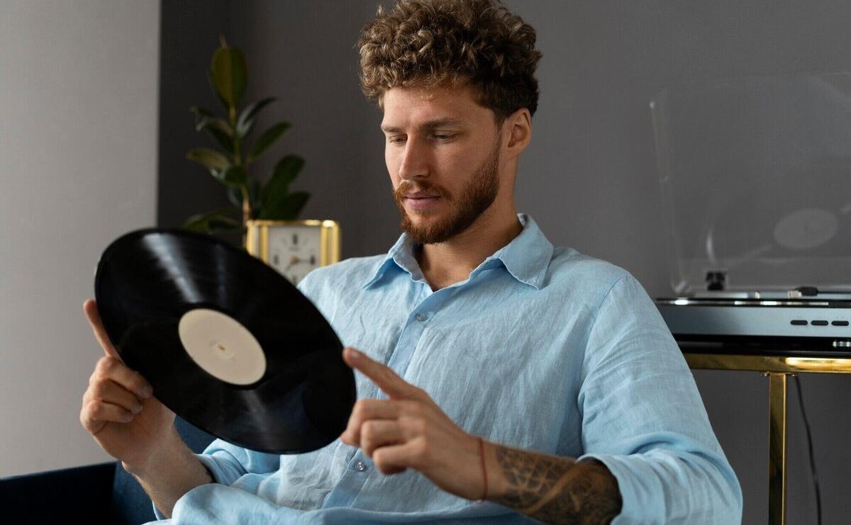 Side view man with vinyl record